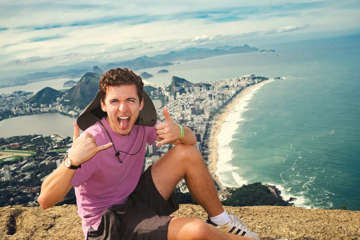 Dylan grinning with thumbs up over Rio de Janeiro