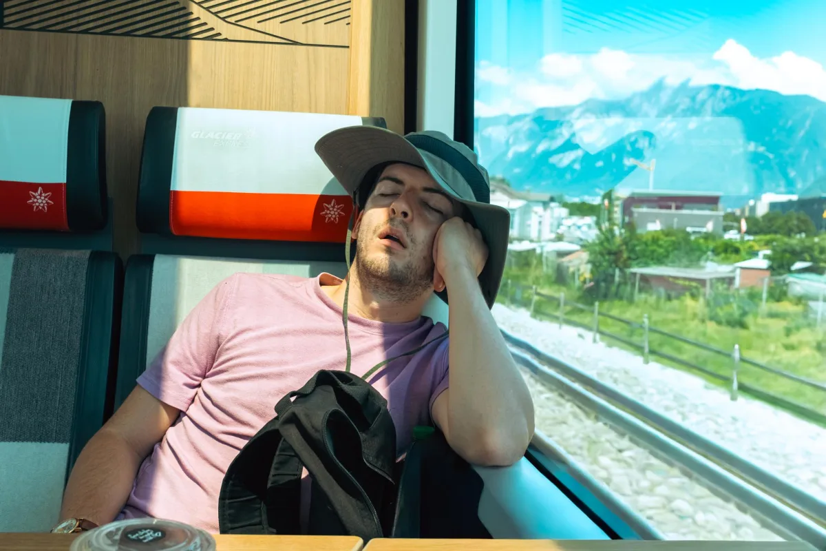 Dylan asleep on a train while the Alps go by